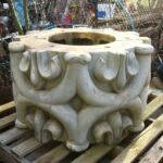 The large pillar, whose origin is unknown, has a hooped design. The photograph shows a section of the pillar before the paint was removed.