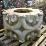 The large pillar, whose origin is unknown, has a hooped design. The photograph shows a section of the pillar before the paint was removed.
