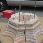 As only one original capital of the two smaller pillars had survived, a replacement was made by potter Alison Robinson in modern Coade Stone.