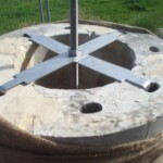 To confer rigidity additional to that inherent in the heavy pillars, each pillar was built around and secured to a central steel rod set into the concrete foundation and with a large nut screwed down at the top.
